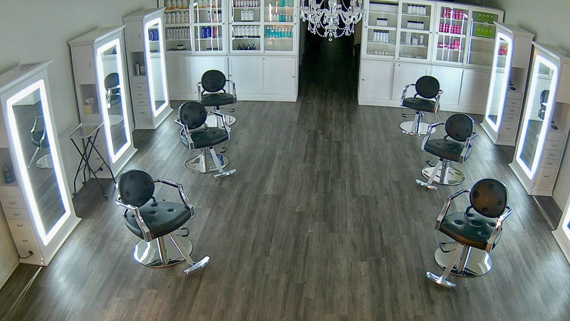 Inside Kija Hair Salon in Irvine, California — styling stations, lit mirrors and retail hair care shelves